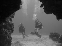 Eden Rock in Bonaire. Divers about to explore a cave. by Kelly N. Saunders 